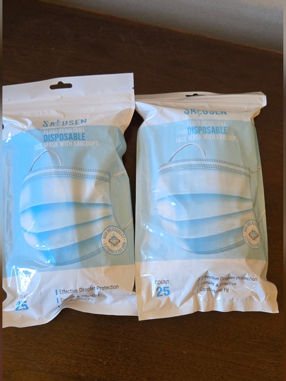Disposable Light Blue Face Masks by - 25 Count Per Pack. Two Packs 50 Count.